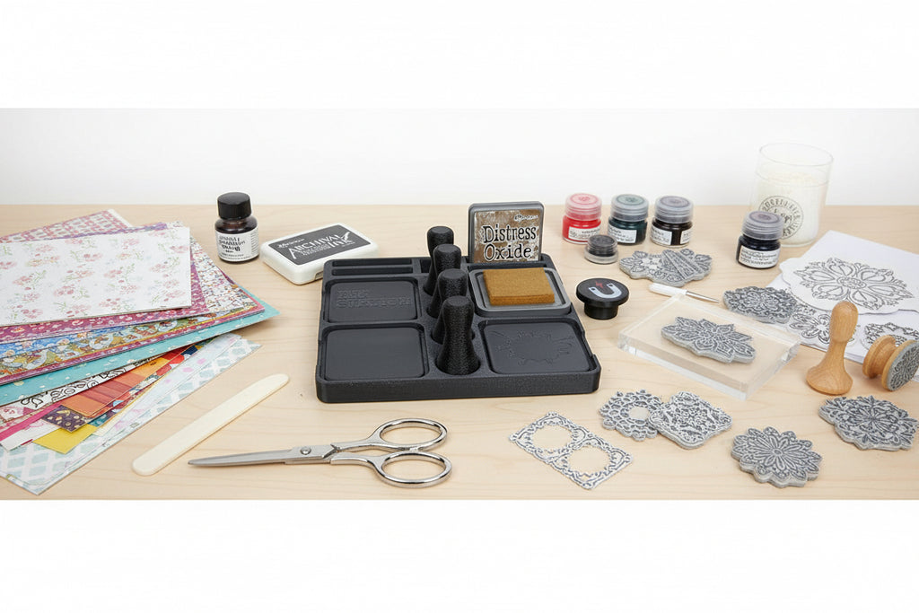 Set of black tools and ink pads on a white surface with a wooden edge.