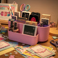 Pink and purple organizer with stationery items including stamps and ink pads.