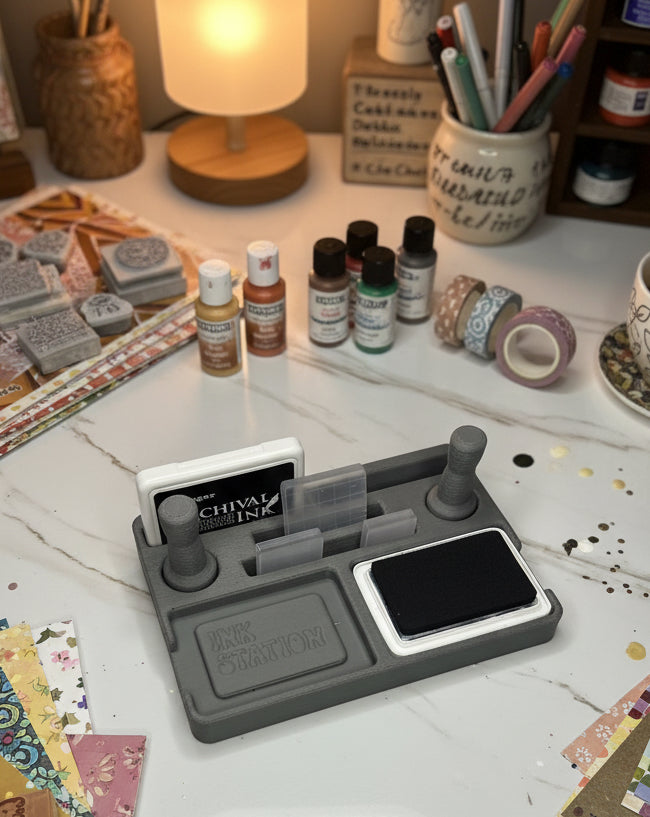 Gray ink station with a black ink pad on a white surface