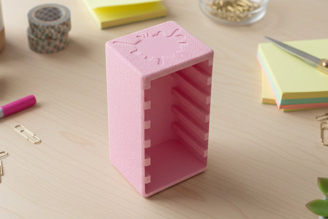 Pink plastic container on a white surface