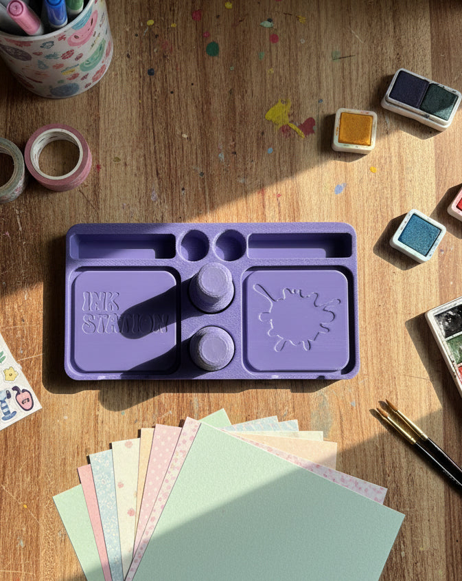Purple ink station with compartments on a white surface