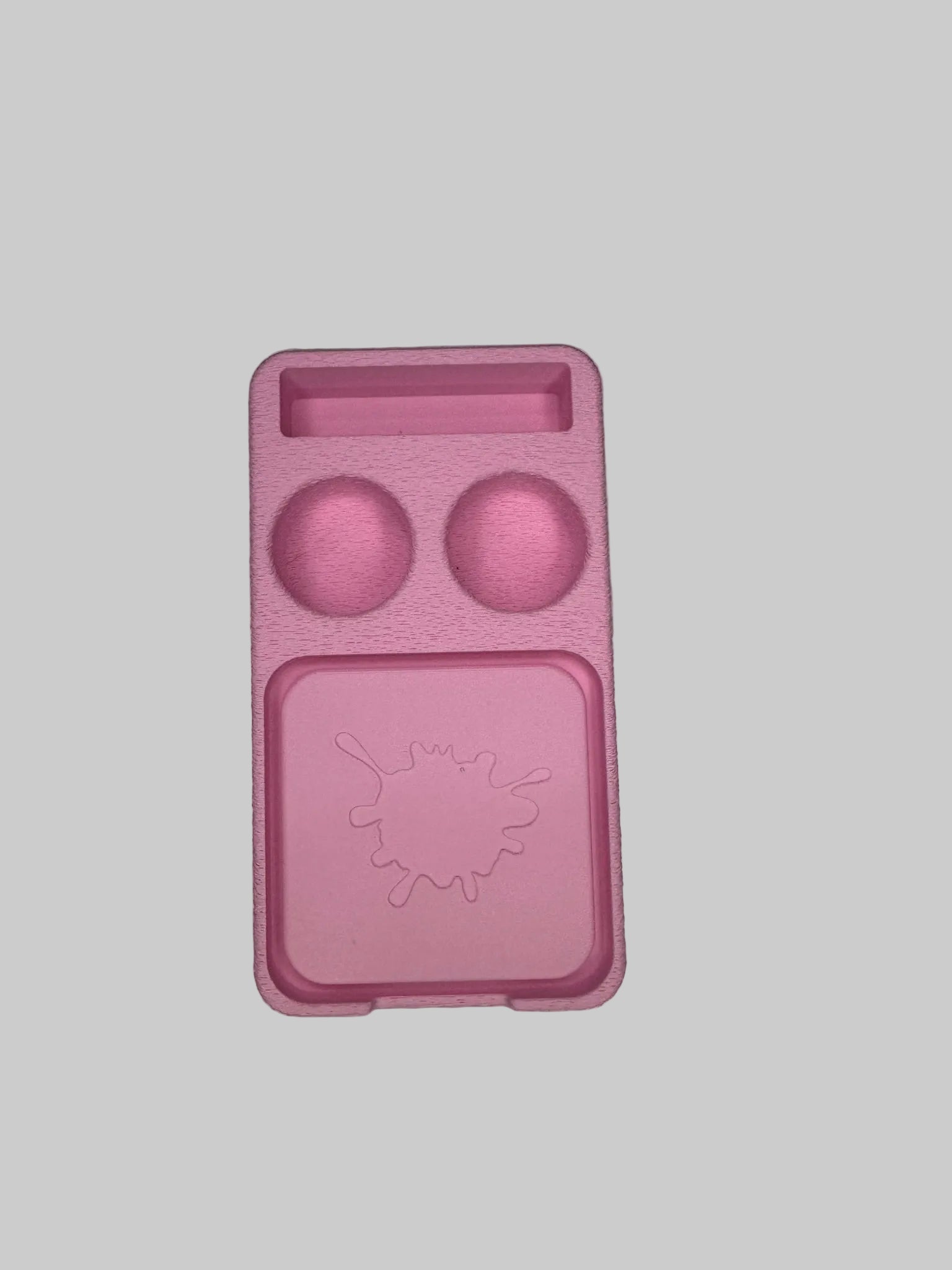 Pink silicone mold on a light gray surface