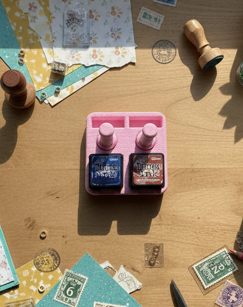 Two ink pads labeled 'Distress Ink' on a pink stand against a white background