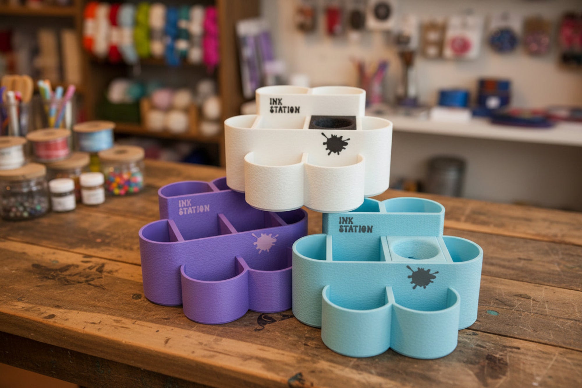 Set of colorful ink station holders with 'Ink Station' branding on a white background