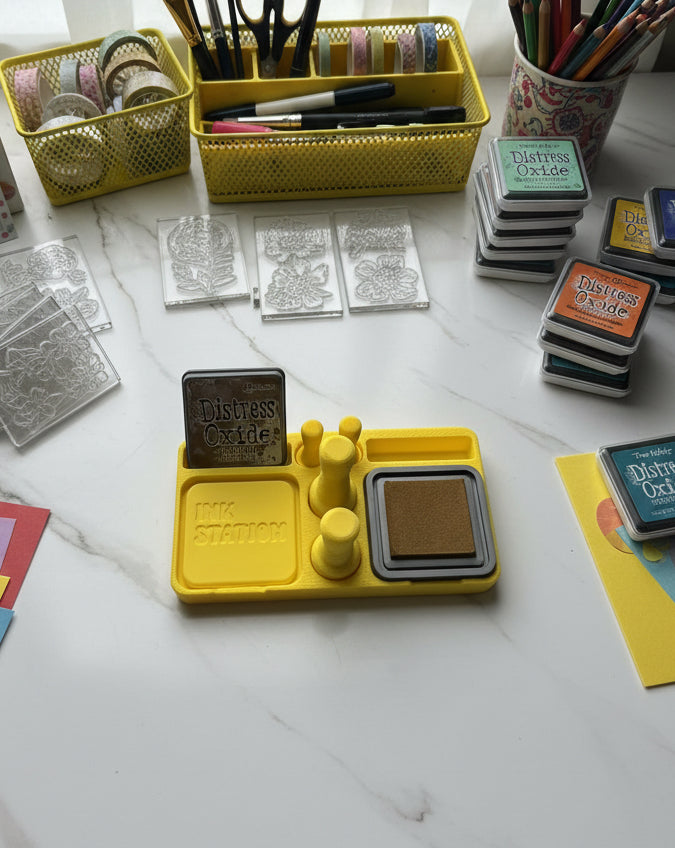 Yellow ink station with ink pads and a 'Distress Oxide' container on a white surface.